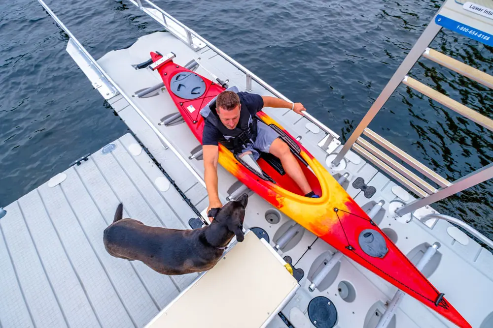 Paddler launching from an EZ Dock low-profile kayak launch